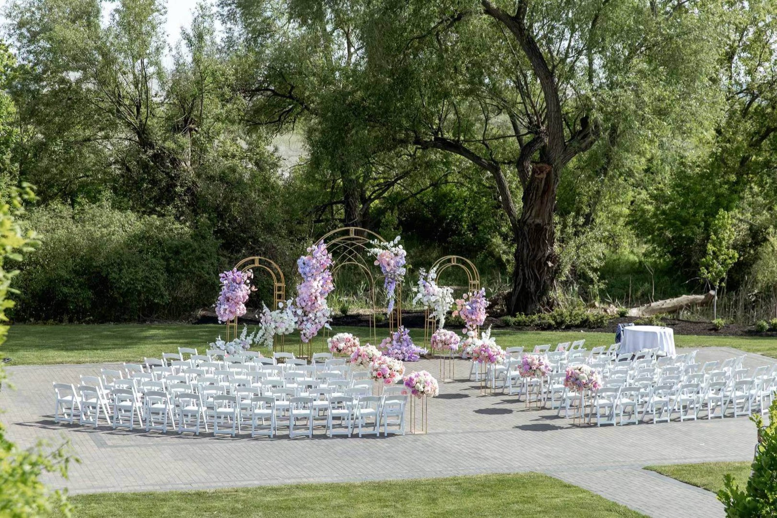 A daylight ceremony set on a lawn, chairs in a curved arc.