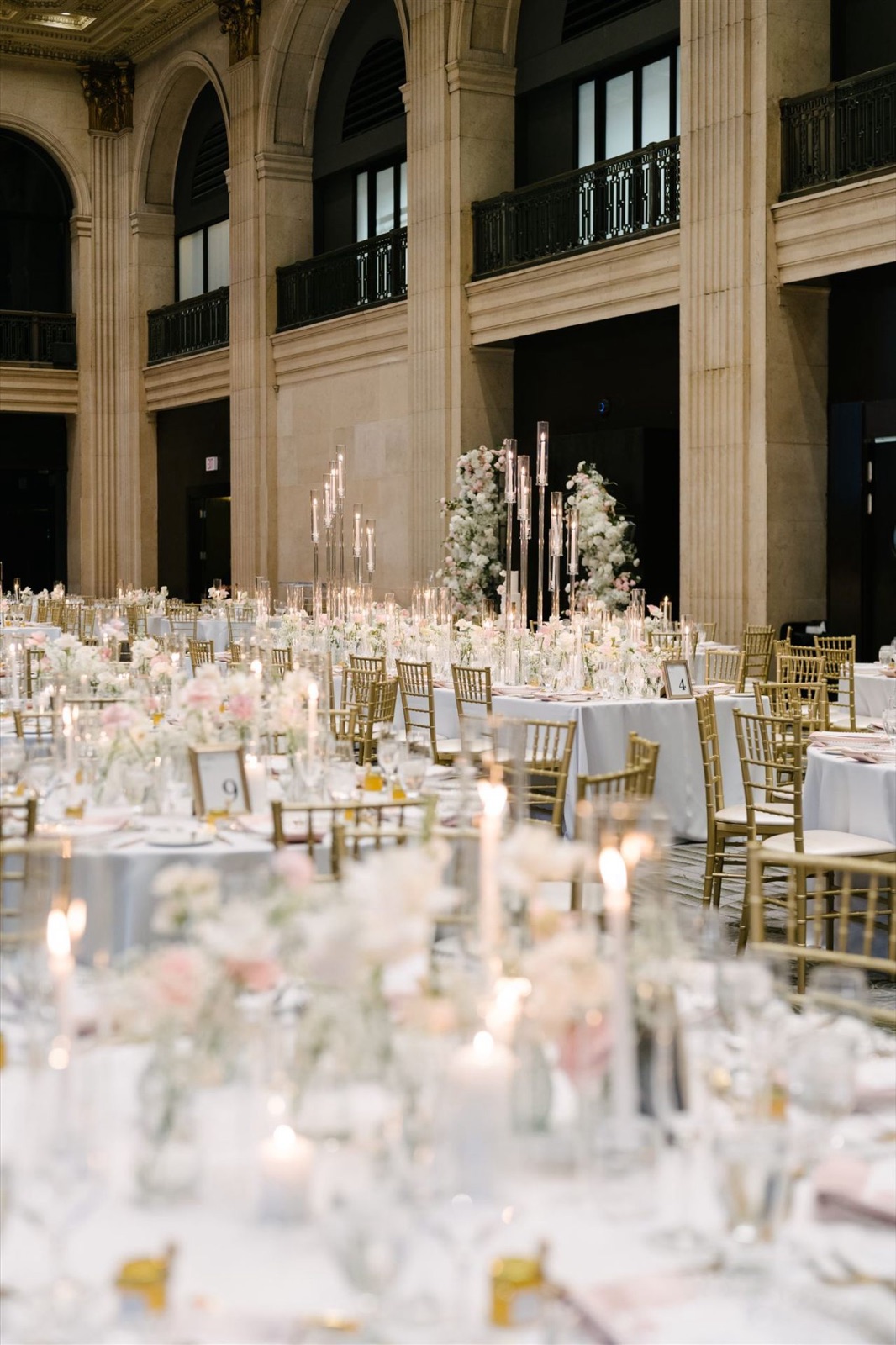 Round tables set under the hotel's arched windows.