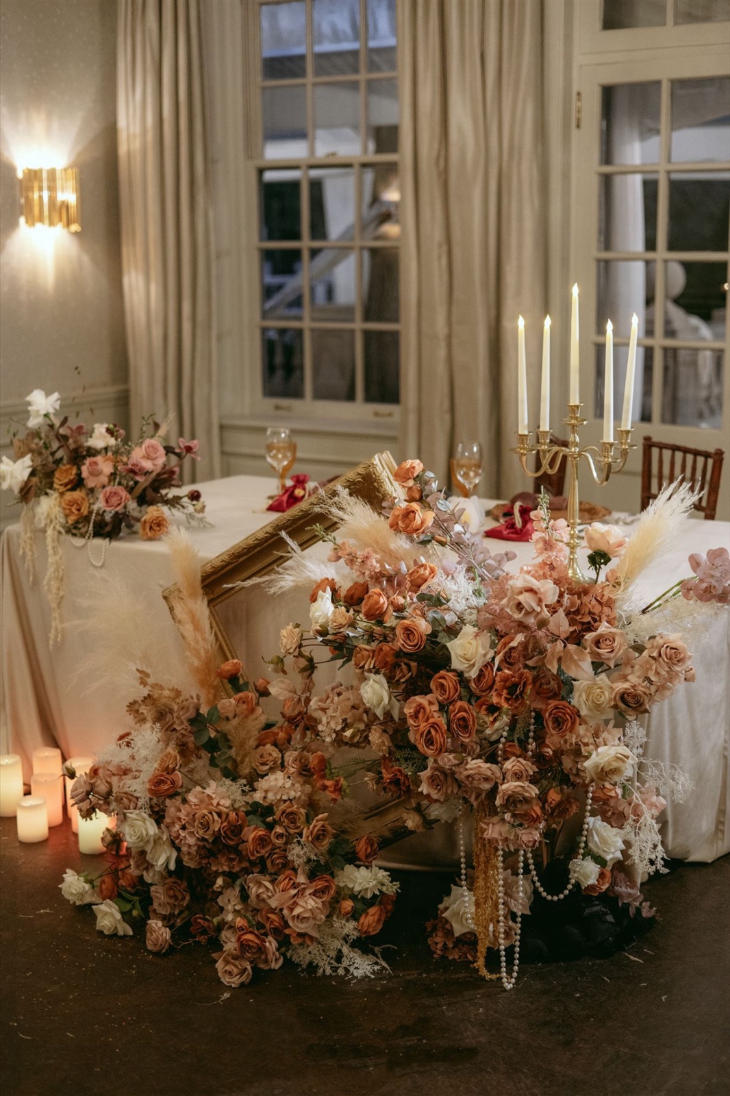 A flower installation spilling from a draped table.
